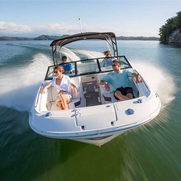 Group of friends going for boat ride in a used Stingray motorboat running in open water Group of friends going for boat ride in a used Stingray motorboat running in open water